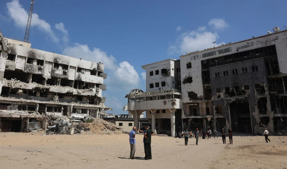 People stand in the compound of the destroyed al-Shifa hospital in Gaza City on August 26, 2025. (AFP)