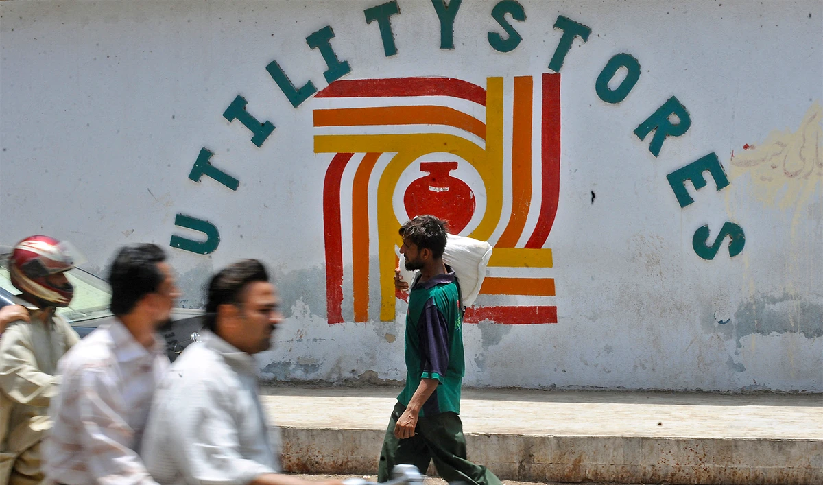 A Pakistani man carries a bag of flour after receiving the flour from the utility store in Karachi on June 12, 2008. (AFP/File)