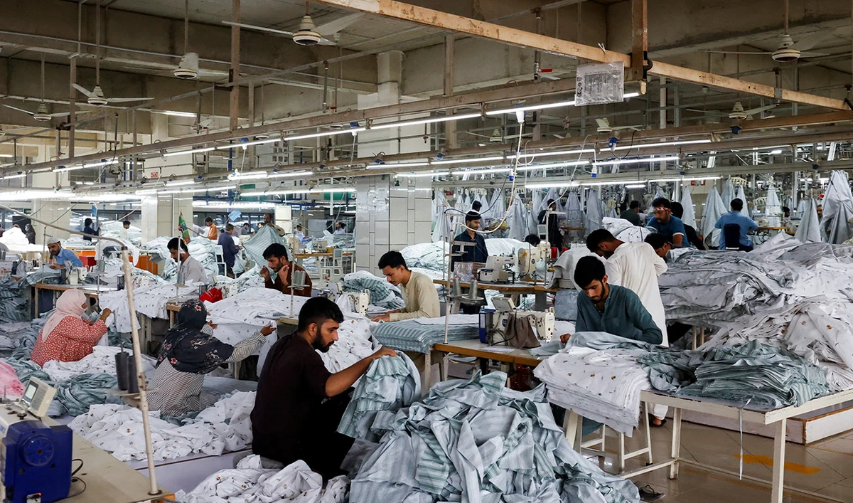 Workers sew, while others sort out fabric sheets, at a stitching unit of the textiles manufacturer of the Liberty Mills Limited, in Karachi, Pakistan August 2, 2025. (Reuters/File)
