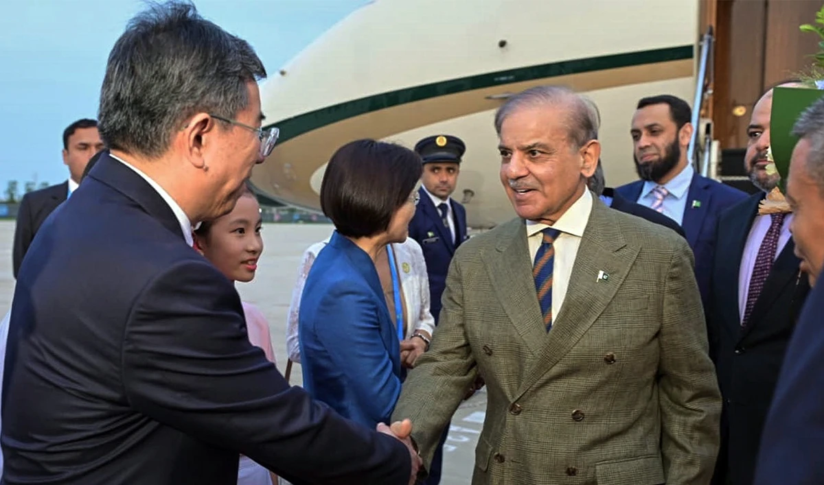 In this photo, released by the Press Information Department, Pakistan’s Prime Minister Shehbaz Sharif (center), is greeted by Chinese officials upon his arrival to attend the Shanghai Cooperation Organization (SCO) Summit, in Tianjin, China, on August 30, 2025. (PID)