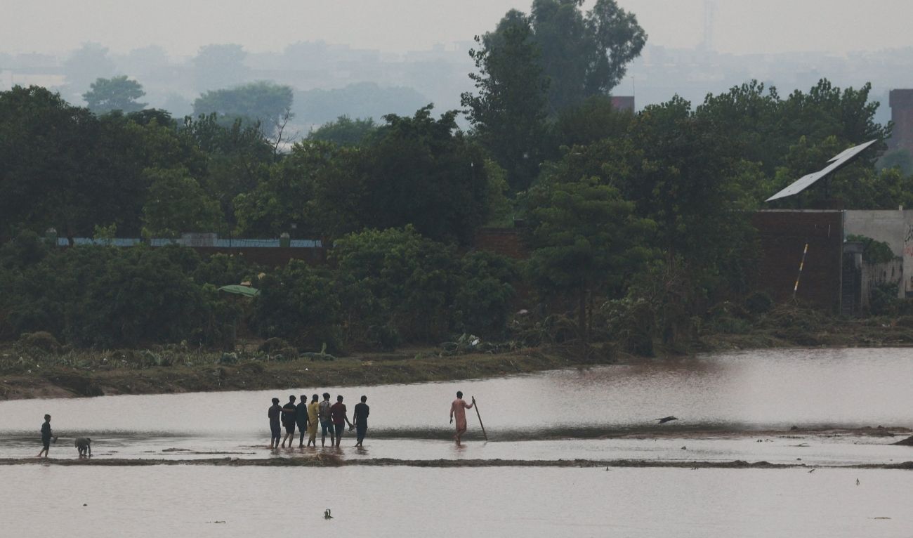 Residents walk after water levels receded along the right bank of the Ravi River, following recent floods caused by monsoon rains, in Lahore, Pakistan August 31, 2025. (REUTERS)