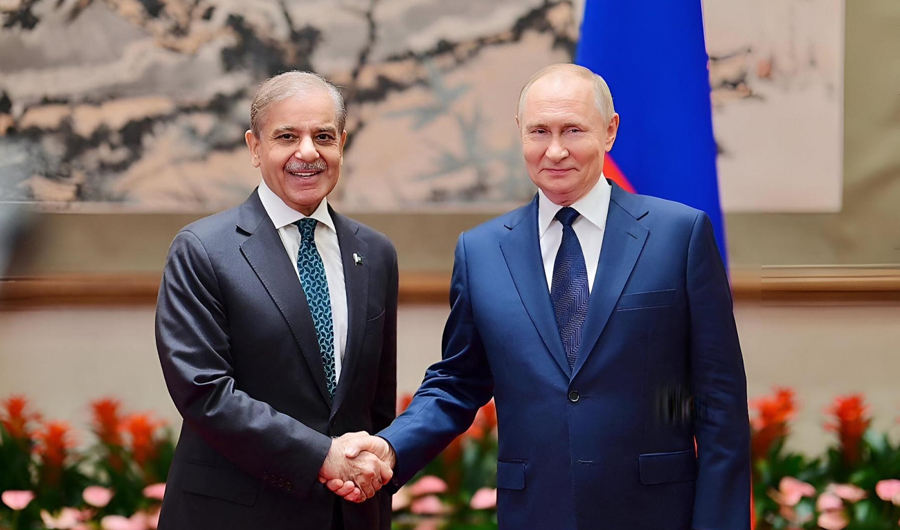 The handout photograph taken and released on September 2, 2025, shows Pakistan Prime Minister Shehbaz Sharif meeting Russian President Vladimir Putin (right) in Beijing, China. (PID)