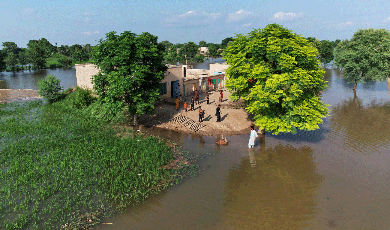 Villagers gather outside their homes, which are surrounding by floodwaters, in Tiba Gheal village, in Jhang district, Pakistan, on September 2, 2025. (AP/File)