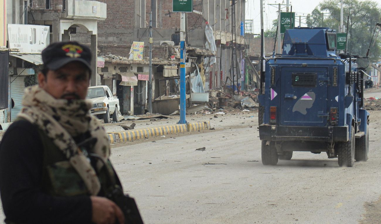 A police officer stands guard on a street with damaged shops in the background, following a militant attack on the Frontier Constabulary (FC) headquarters in Bannu, Khyber Pakhtunkhwa province, in Pakistan September 2, 2025. (Reuters)