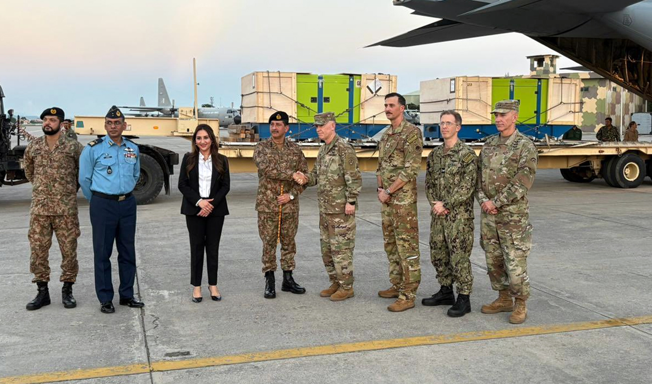 Natalie Baker (third left), Chargé d’Affaires of US Embassy in Pakistan, along with other officials poses for a group photo while handing over emergency supplies for Pakistani flood affectees at Nur Khan Air Base in Rawalpindi. (@MohsinnaqviC42/X)