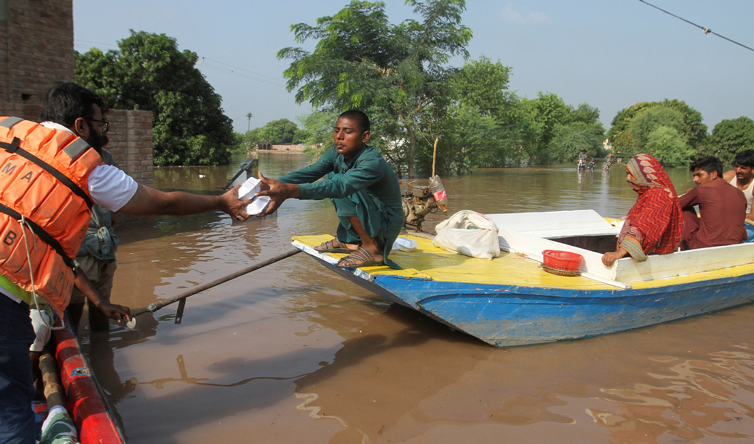 A man, who fled from a flooded area along with his family, receives food handouts, following monsoon rains and rising water levels of the Chenab River, in Muzaffargarh, Punjab province, Pakistan, on September 5, 2025. (REUTERS)