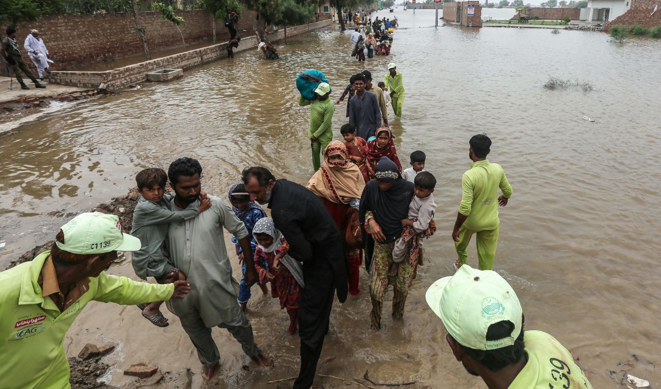 Flood-affected residents wade through floodwaters in Jalalpur Pirwala of the Multan district in Punjab province on September 8, 2025, after the Chenab River overflowed following heavy monsoon rains. (AFP/ file)