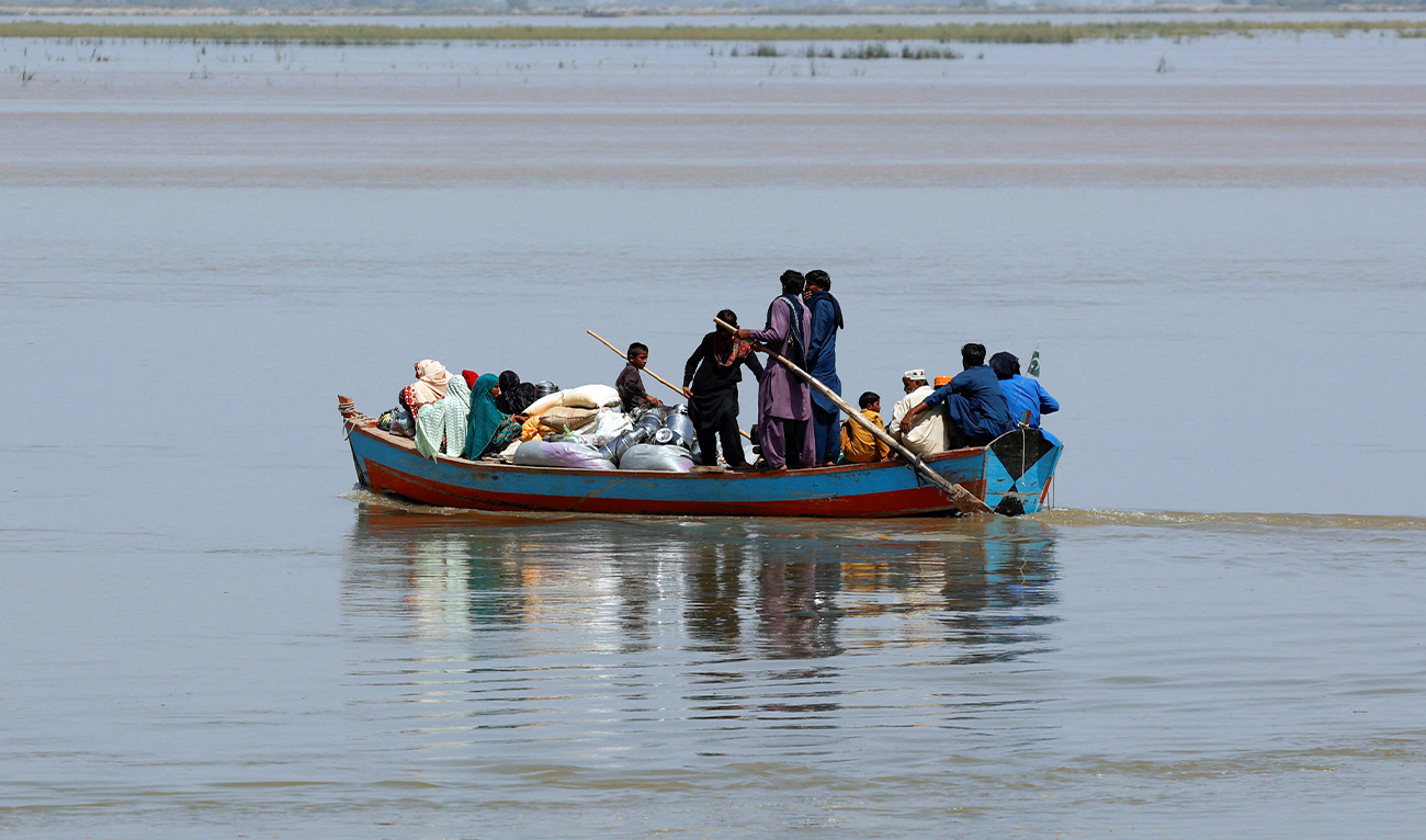 People with their supplies travel in a boat as they head to their village along the Indus River, in Sukkur district of Sindh province, Pakistan, on September 14, 2025. (REUTERS)