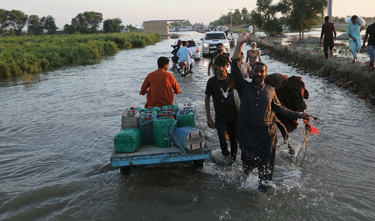 Villagers wade through the floodwaters as they make their way to safer places in Alipur, a town of Muzaffargarh district in Punjab province of Pakistan on September 12, 2025. (AFP/File)