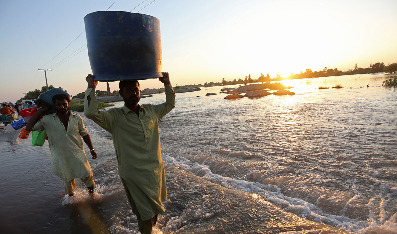 Villagers wade through the floodwaters as they make their way to safer places in Alipur, a town of Muzaffargarh district in Punjab province on September 12, 2025, after the Head Panjnad overflowed following heavy monsoon rains. (AFP/ file)