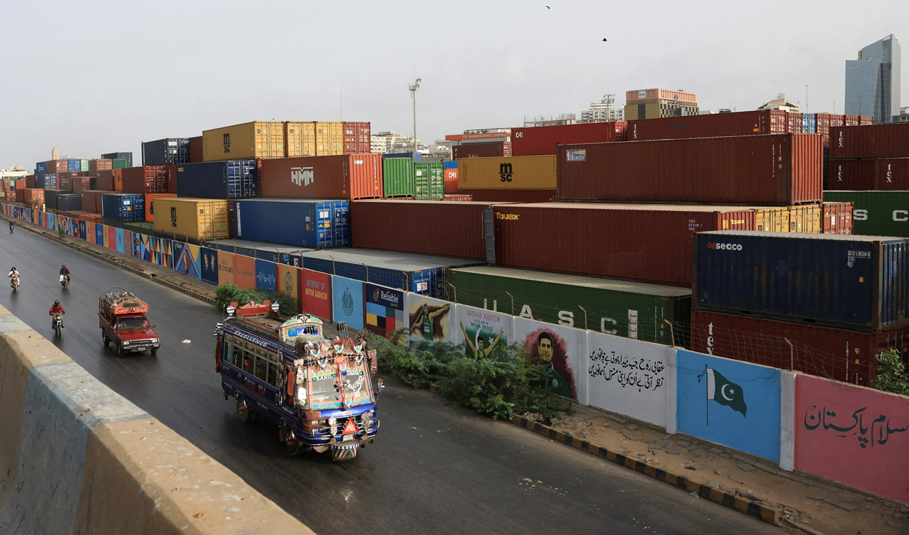 Vehicles move past a shipping container yard along a road in Karachi, Pakistan, on June 10, 2025. (REUTERS/File)