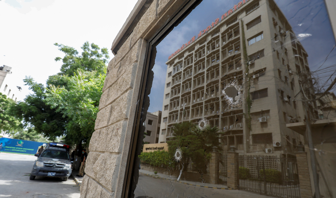 The Pakistan Stock Exchange building is reflected in the bullet riddled window of the security check post after an attack in Karachi, Pakistan June 29, 2020. (REUTERS/File)