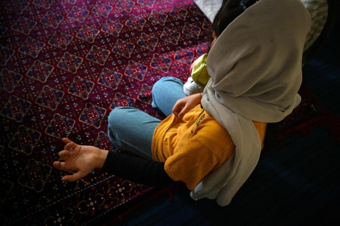 In their Pakistan safehouse, Shayma and her family try to keep their voices low so their neighbors don’t overhear their Afghan mother tongue. (AFP)