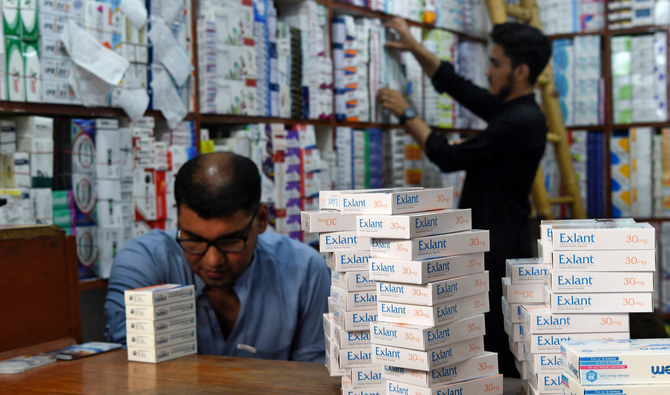Pharmacists arrange medicines at a pharmacy shop in Peshawar on September 1, 2021. (AFP/File)
