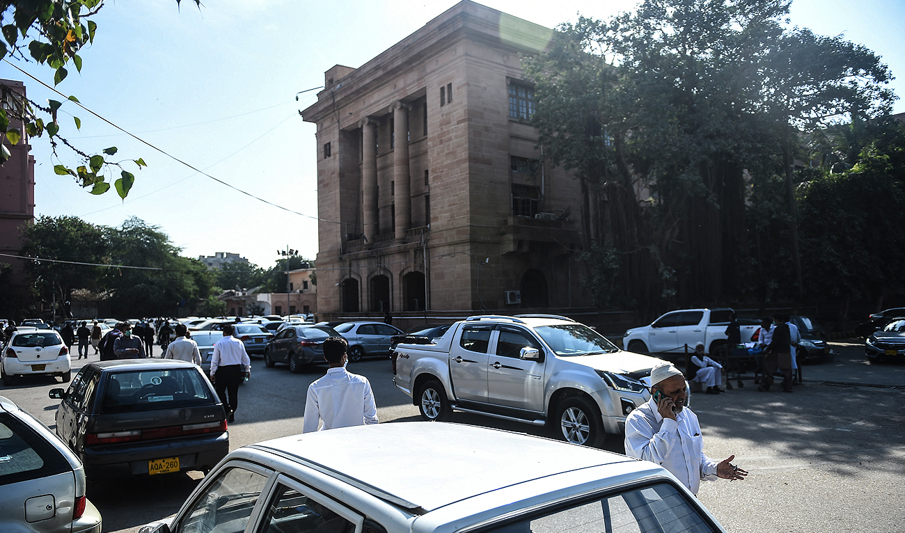 In this file photo, taken on December 24, 2020, people walk outside the Sindh High Court in Karachi. (AFP/File)