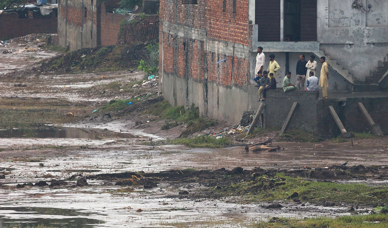Residents look on after water levels receded along the right bank of the Ravi River, following recent floods caused by monsoon rains, in Lahore, Pakistan on August 31, 2025. (REUTERS/File)
