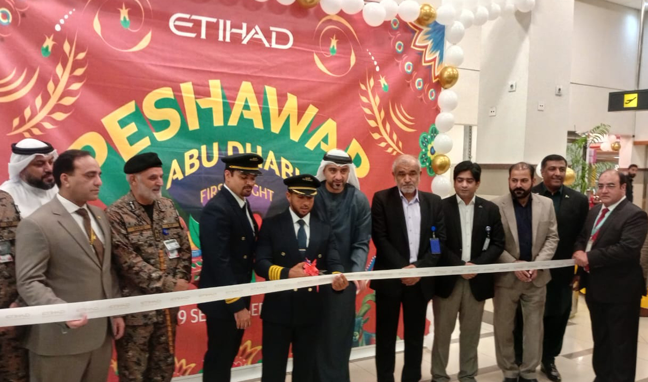 Officials gesture during the ceremony to mark the resumption of Etihad Airways operations as the first flight from Abu Dhabi lands in Peshawar on September 29, 2025. (Handout/PAA)