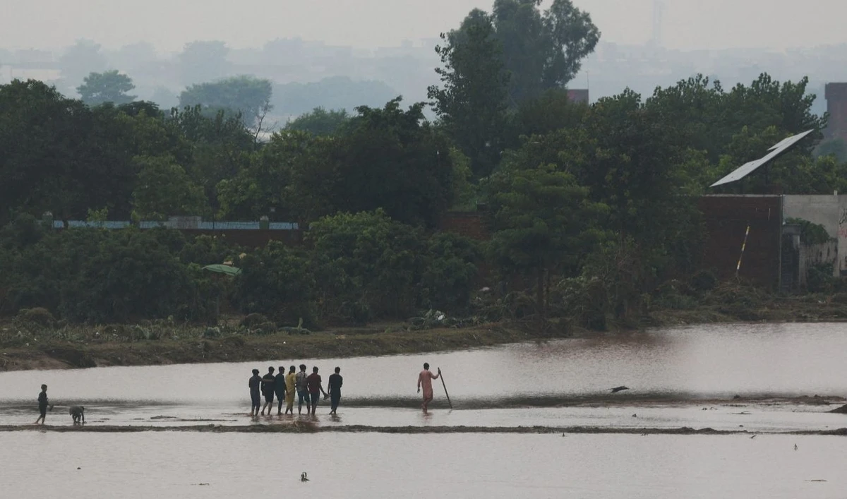 Residents walk after water levels receded along the right bank of the Ravi River, following recent floods caused by monsoon rains, in Lahore, Pakistan August 31, 2025. (REUTERS)