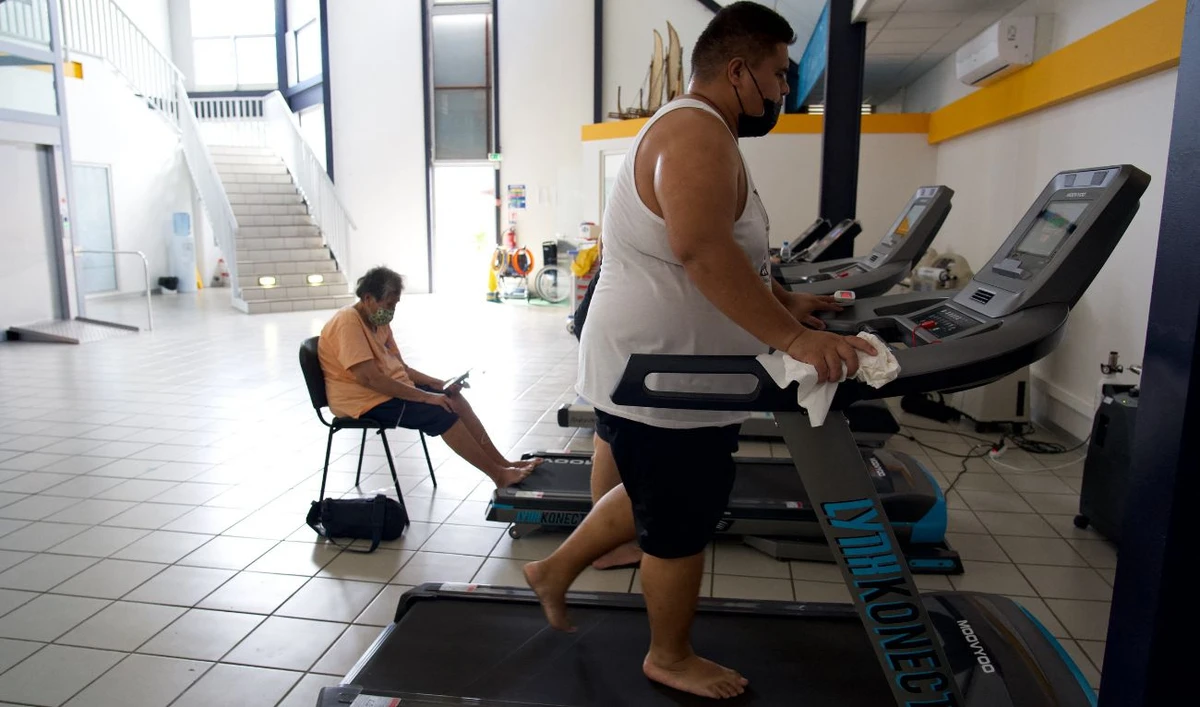 A patient walks on a treadmill to work on endurance and cardio at the ORA ORA follow-up care and rehabilitation centre (Soins de Suite et Readaptation - SSR) for patients with overweight issues or obesity, in Pirae, Tahiti, French Polynesia, on September 10, 2021. (File/ AFP)