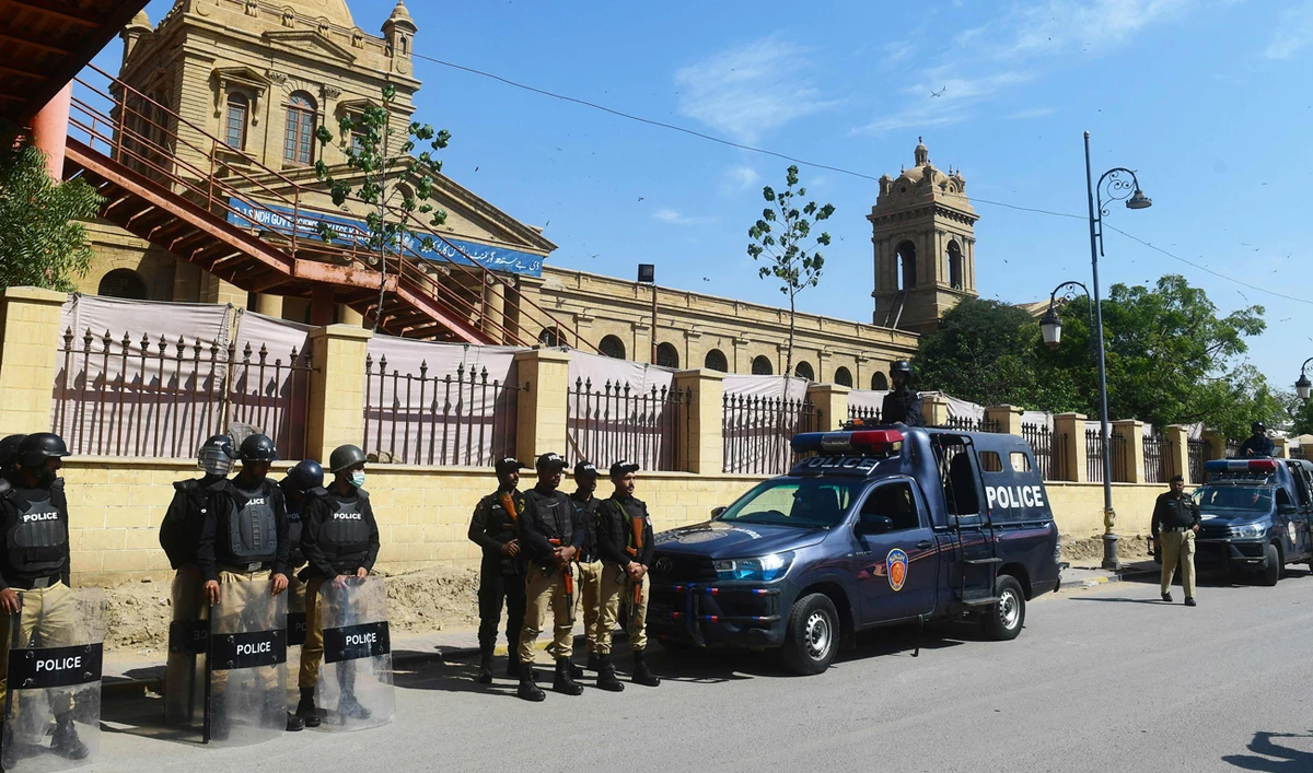 In this file photo, taken on February 8, 2024, policemen stand guard on a street in Karachi. (AFP/File)