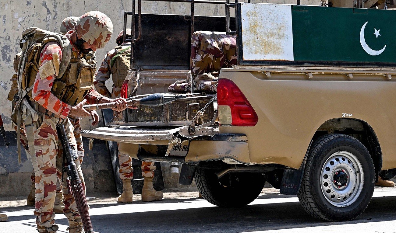 Security personnel stand armed beside a military vehicle at an explosion site outside the Frontier Corps (FC) headquarters in Quetta, Pakistan, on September 30, 2025. (AFP/File)