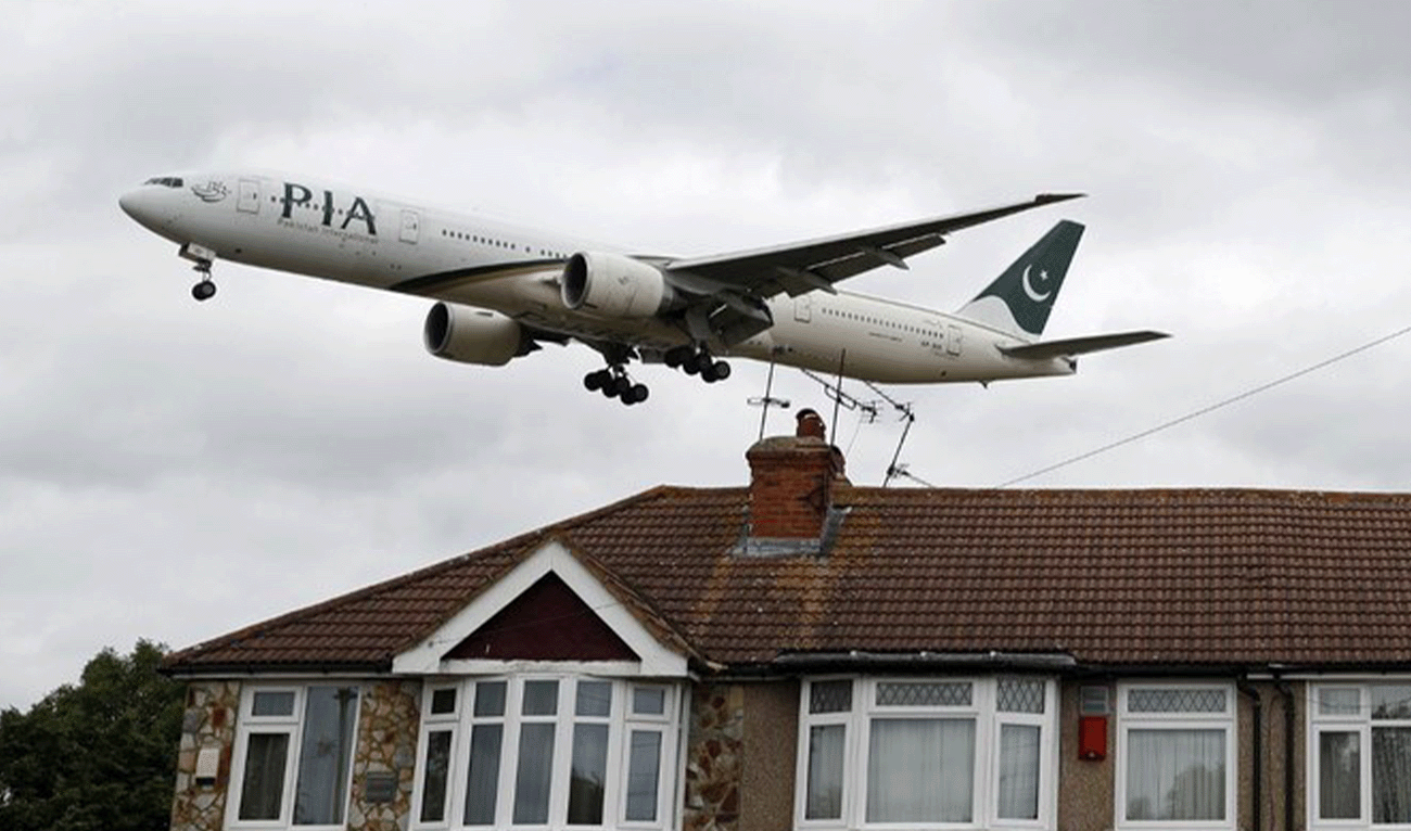 A Pakistan International Airlines (PIA) Boeing 777 comes in over houses to land at Heathrow Airport in west London on June 8, 2020. (AFP/File)