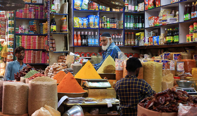 A man and workers are seen at a spice and grocery shop in a market in Karachi, Pakistan, on June 10, 2025. (REUTERS/File)