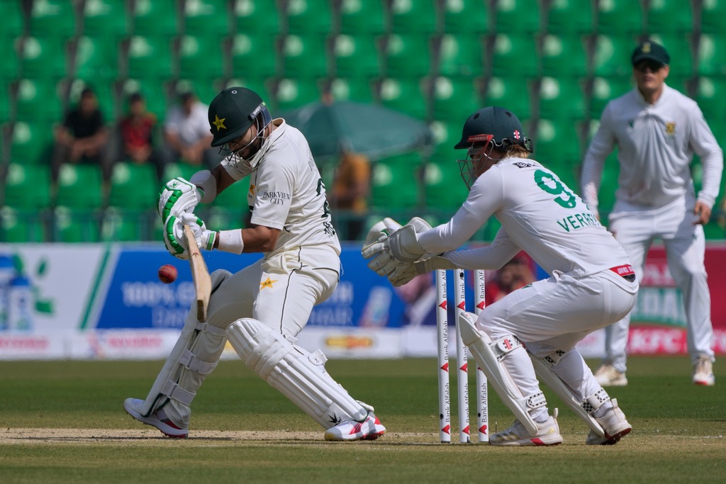 Pakistan's Imam-ul-Haq, left, plays a shot during the first day of of first test cricket match between Pakistan and South Africa, in Lahore, Pakistan, Sunday, Oct. 12, 2025. (AP)