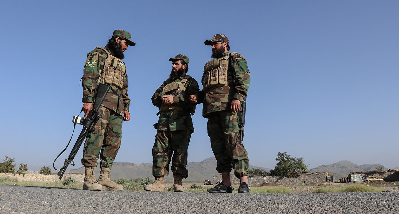 Taliban security personnel stand guard along a road in the Zazai Maidan district of Khost province near the Afghanistan-Pakistan border on October 12, 2025. (AFP)
