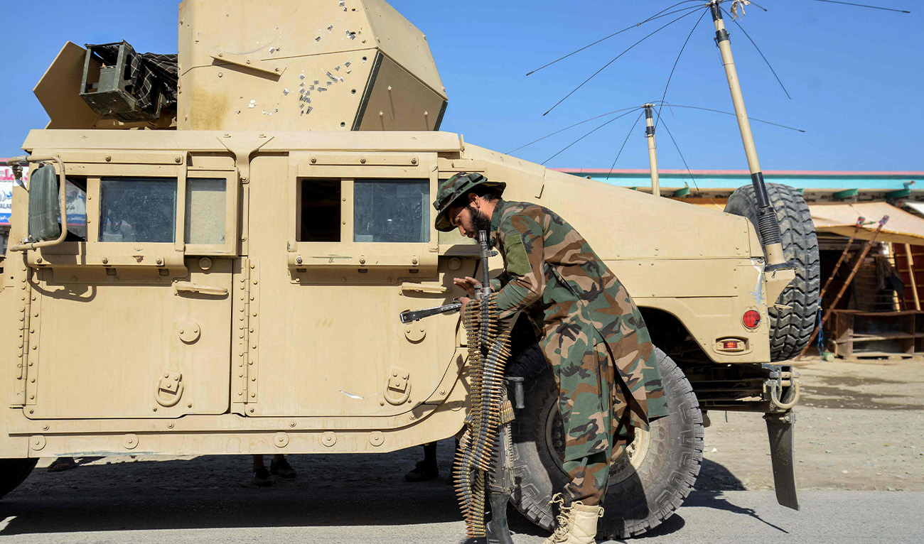 A Taliban security personnel carries a gun and ammunition in the Shorabak district near the Afghanistan-Pakistan border on October 12, 2025. (AFP)