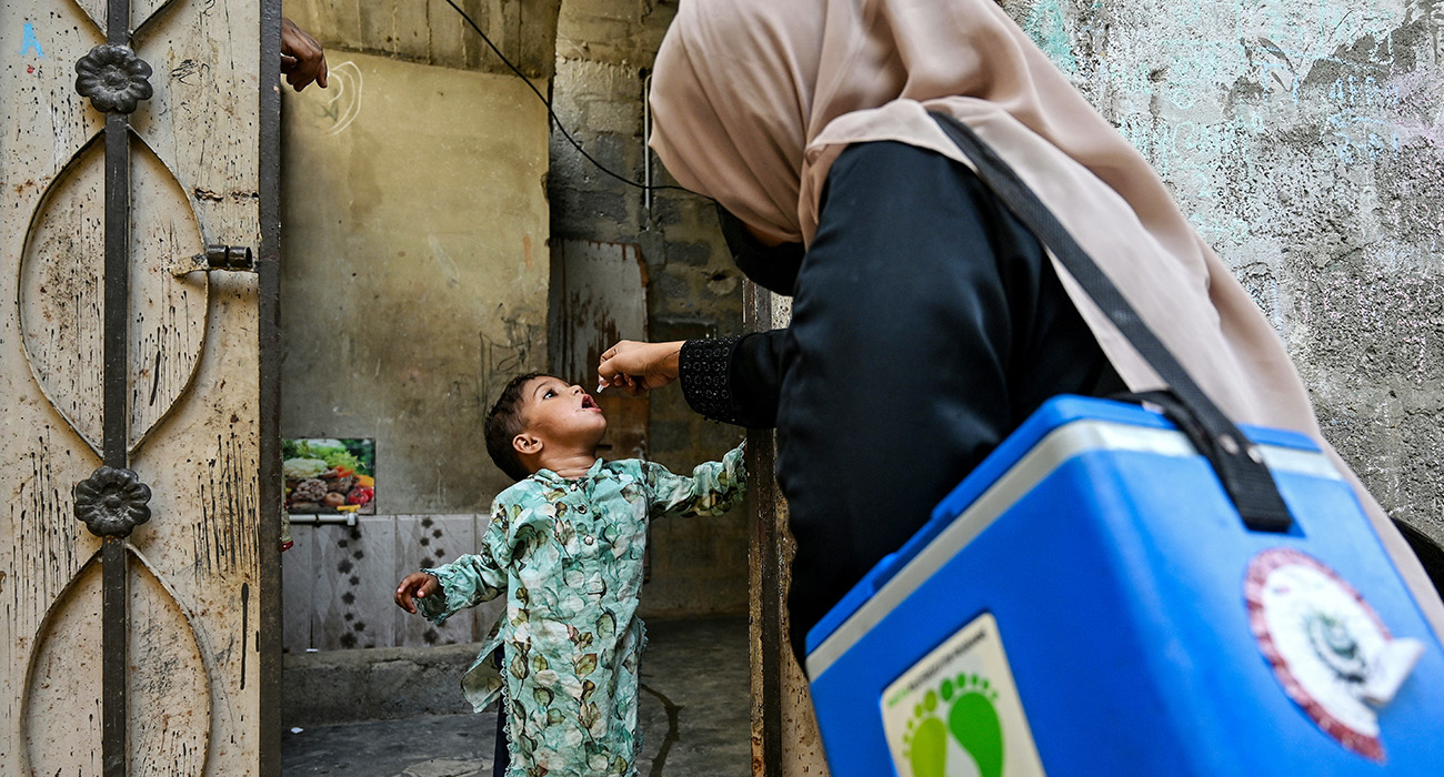 A health worker administers polio drops to a child for vaccination on the first day of a nationwide week-long poliovirus eradication campaign in Karachi on October 13, 2025. (AFP)