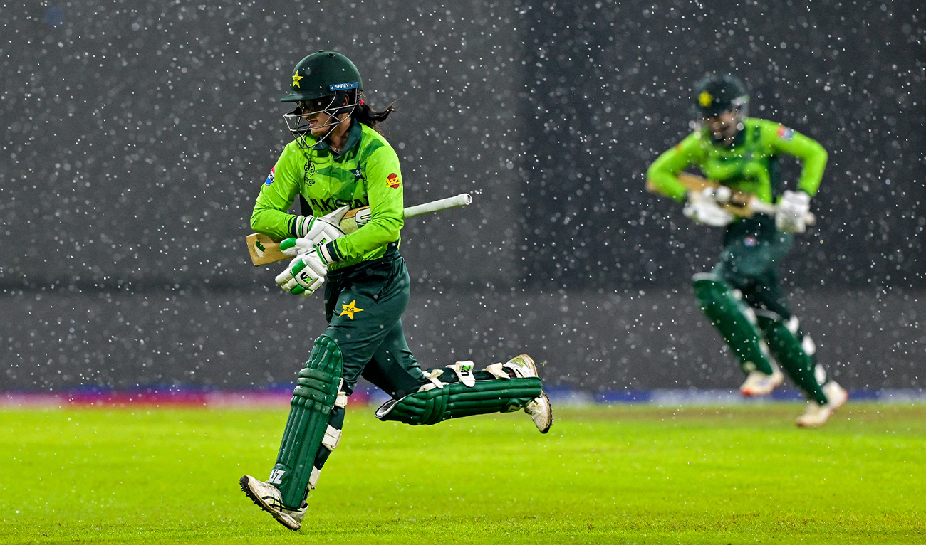 Pakistan’s Muneeba Ali and Omaima Sohail (right) run toward the pavilion as rain stops play during the ICC Women’s Cricket World Cup 2025 one-day international (ODI) match between Sri Lanka and Pakistan at the R. Premadasa International Cricket Stadium in Colombo on October 24, 2025. (AFP)