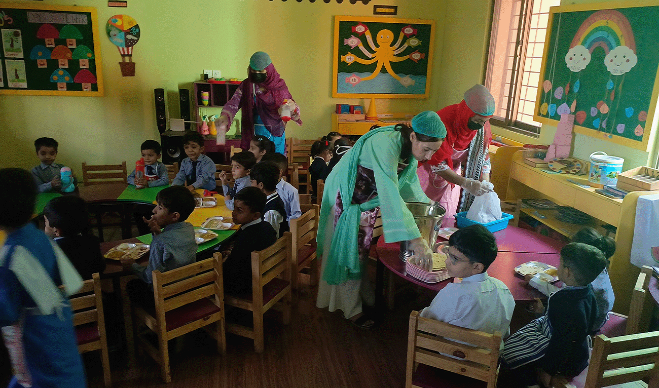 Children being served free meals at a school in Islamabad’s I-8 sector on October 23, 2025. (AN Photo)