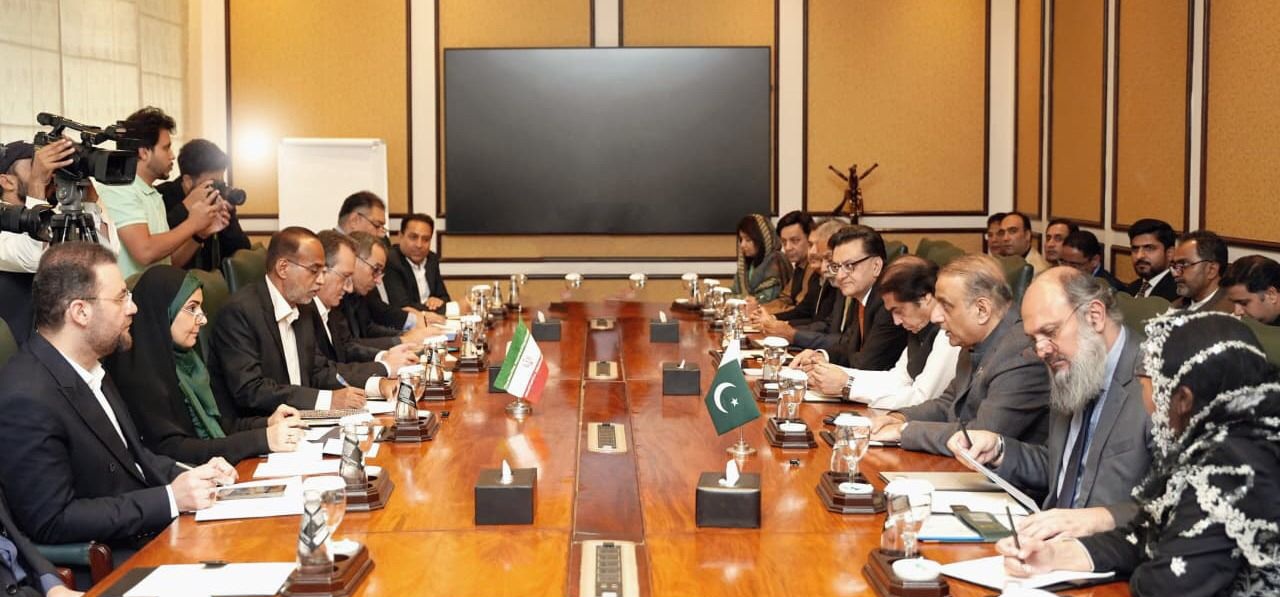 This photo, released on October 25, 2025, shows officials from Pakistan and Iran gesture during a meeting in Islamabad. (APP)