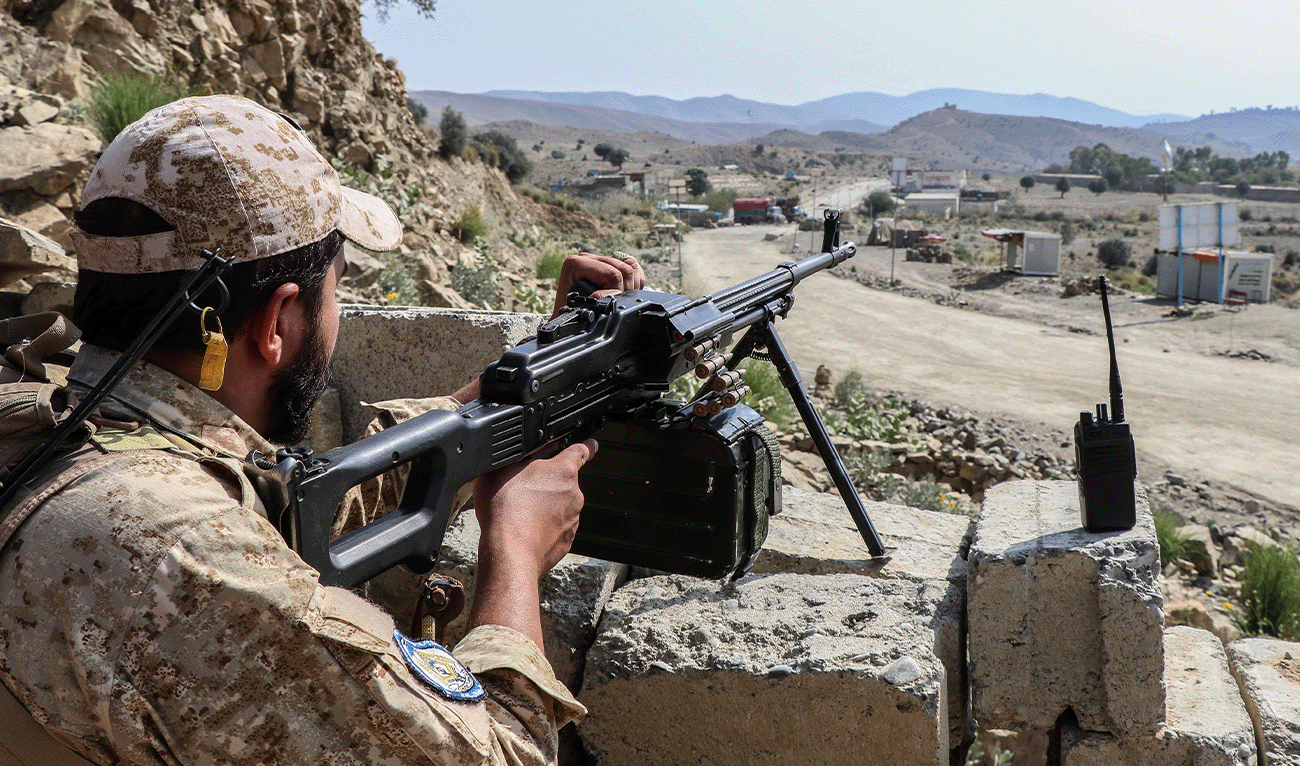 A Taliban security personnel stands guard along a road near the Ghulam Khan zero-point border crossing between Afghanistan and Pakistan in Gurbuz district in the southeast of Khost province on October 20, 2025. (AFP/File)