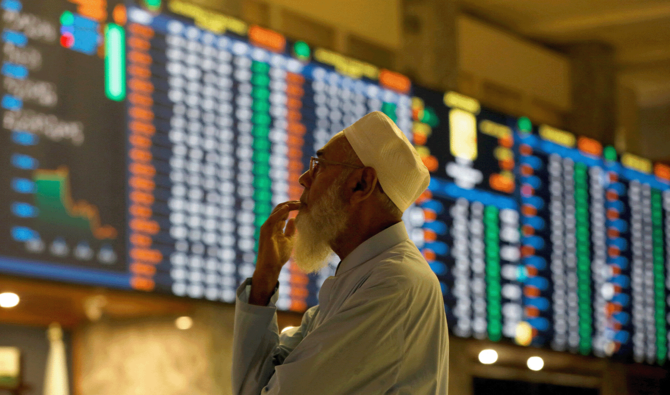 A stock broker reacts while monitoring the market on the electronic board displaying share prices during trading session at the Pakistan Stock Exchange, in Karachi, Pakistan July 3, 2023. (Reuters/File)