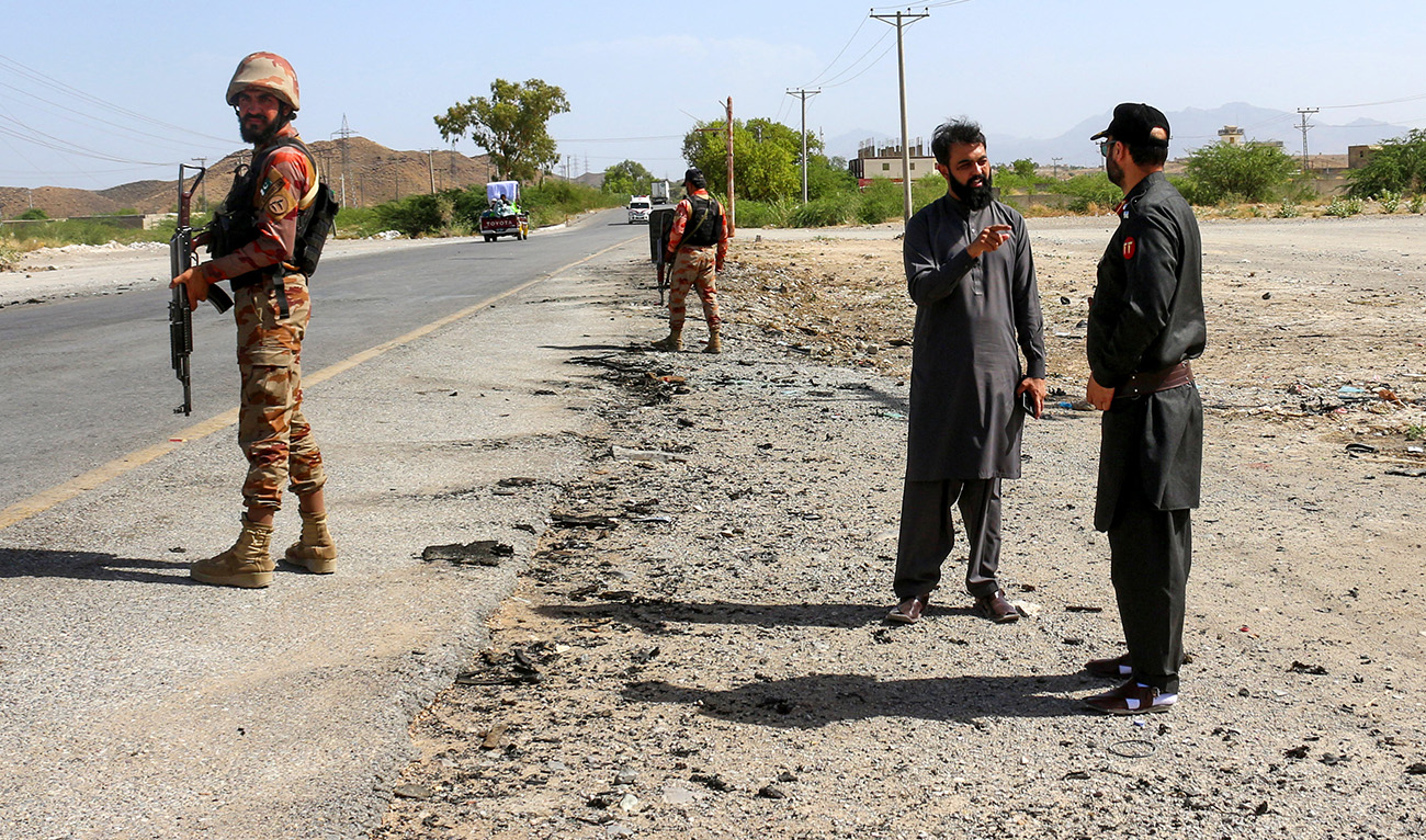 Security personnel stand guard at the site of a school bus bombing in Khuzdar district of Balochistan province on May 21, 2025. (AFP/ File)