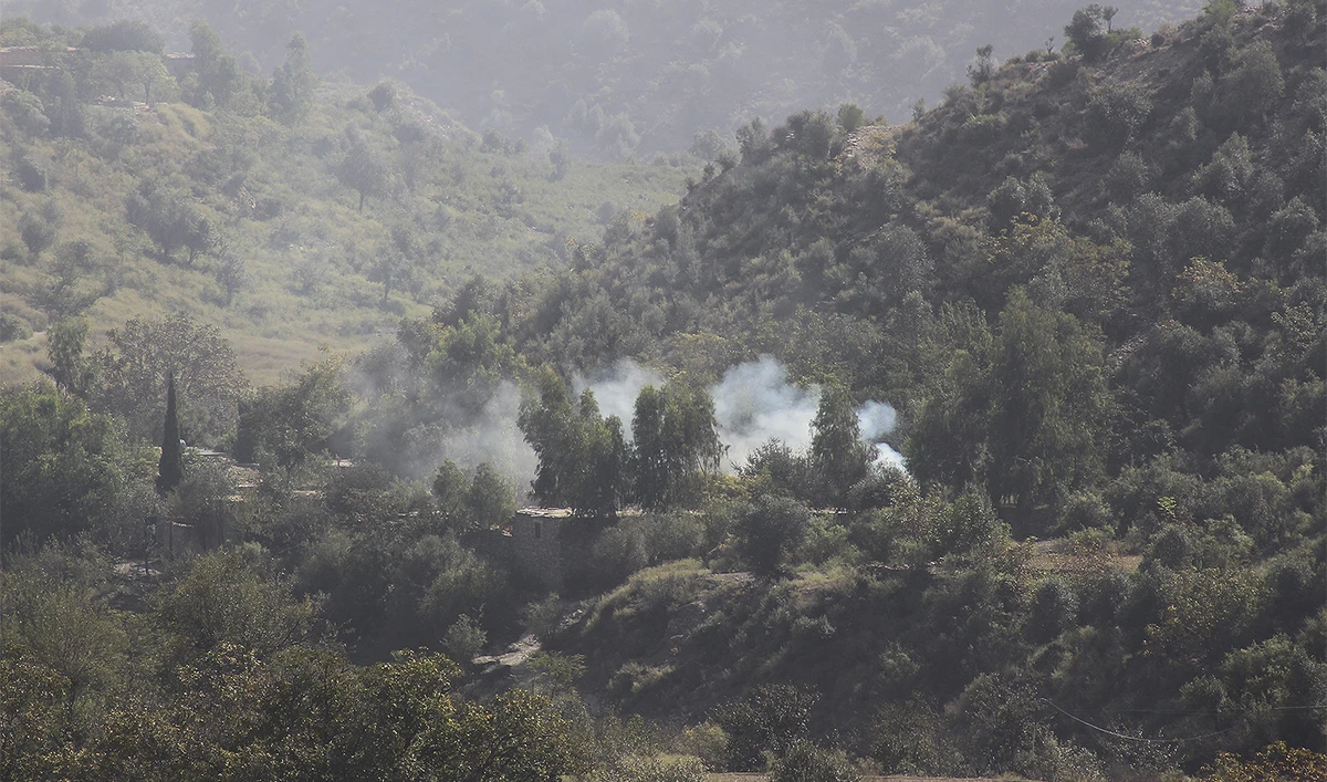 Smoke rises from a hillside following overnight clashes between Afghan and Pakistani forces along the border in the Zazai Maidan district of Khost province, Afghanistan, on October 12, 2025. (AP)