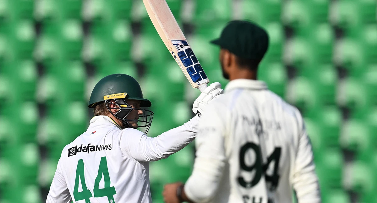 South Africa's Ryan Rickelton (L) celebrates after scoring half century (50 runs) during the second day of the first Test cricket match between Pakistan and South Africa at the Gaddafi Stadium in Lahore on October 13, 2025. (AFP)