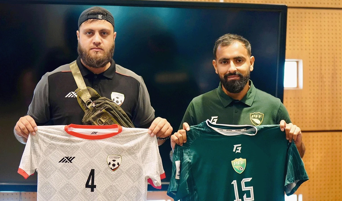 Manager of Pakistan's football team, Shahzaib Ahmed Khan (right), holding jersey of Pakistan's football team with representative of Afghanistan's football team holding his team's jersey to pose for a picture shared by Pakistan Football Federation on October 13, 2025. (Pakistan Football Federation/Facebook)