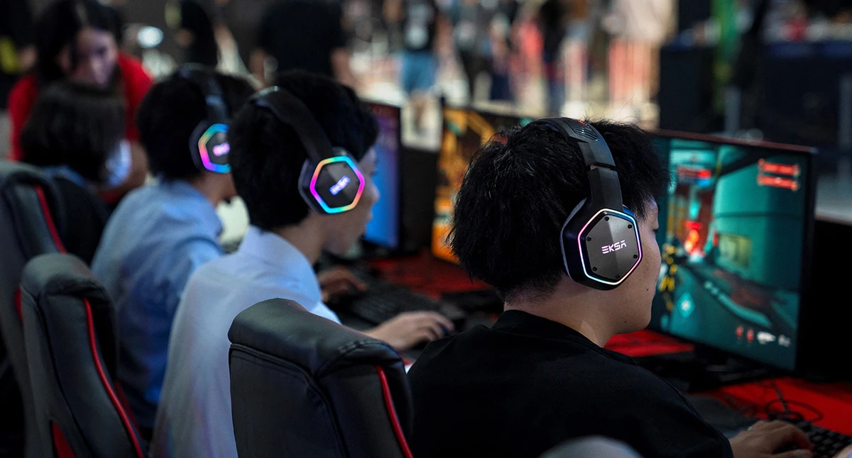 Visitors play video games at a booth during the preview day for the annual Tokyo Game Show at Makuhari Messe in Chiba City, Chiba Prefecture on September 25, 2025. (AFP/ file)