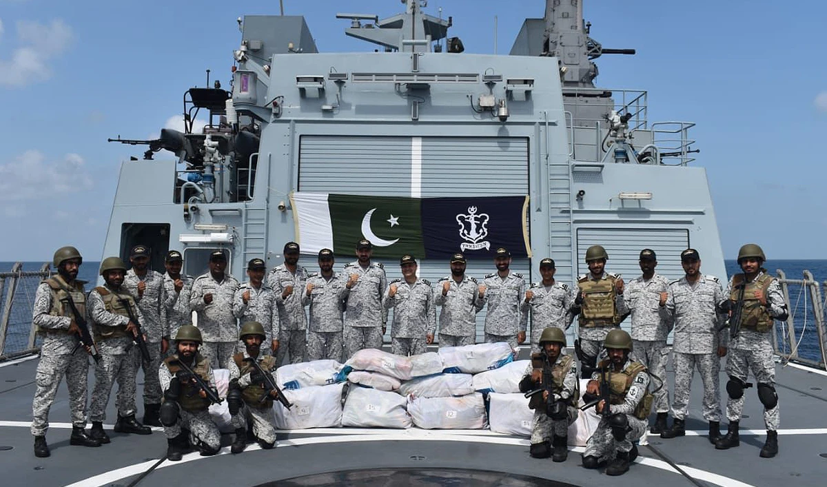 In this handout photograph, released by the Director General Public Relations of Pakistan Navy, Navy personnel gesture for a group photo after a seizure of 380 kilograms of highly valuable drugs in an operation in the North Arabian Sea on June 1, 2024. (Photo courtesy: Pakistan Navy/File)