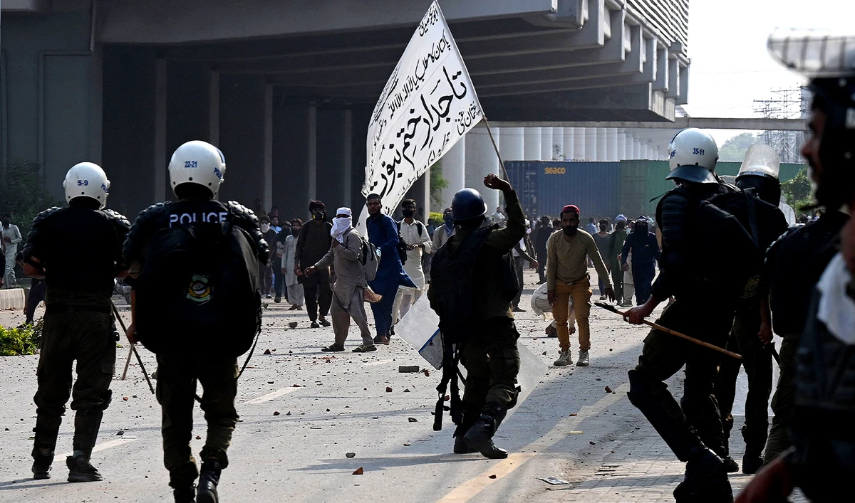 Activists of the Tehreek-e-Labbaik Pakistan (TLP) party clash with police after authorities blocked the road with shipping containers, in Lahore on October 10, 2025, ahead of their pro-Palestinian march towards Islamabad. (AFP/File)