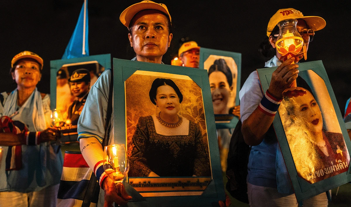 Royal supporters hold portraits of Thailand's Queen Mother Sirikit during a ceremony to celebrate her 93rd birthday in Bangkok on August 12, 2025. (AFP/File)