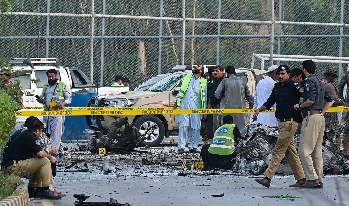 Security personnel gather at the site of the bomb blast in Hayatabad area of Peshawar, Pakistan, on July 18, 2023. (AFP/File)