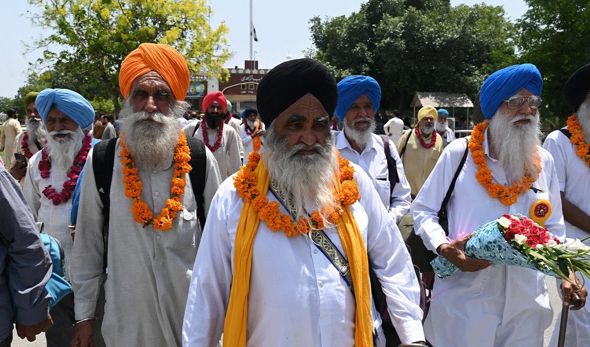 Indian Sikh pilgrims arrive in Pakistan through the Pakistan-India Wagah border post, about 35km from Lahore on June 8, 2023, to mark the annual Martyrdom Day of Sikh Guru Arjan Dev. (AFP/File)