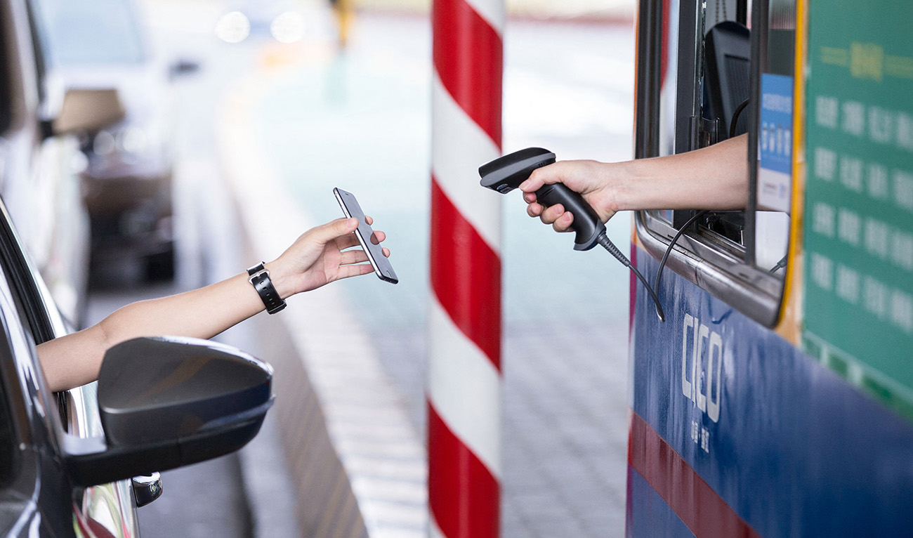 This picture taken on August 26, 2016 shows a driver uses his smartphone to pay the highway toll by way of Alipay, an app of Alibaba's online payment service, at Pengbu toll station on the Hangzhou-Ningbo Expressway in Hangzhou in Zhejiang province on September 21, 2016. (AFP/ file)