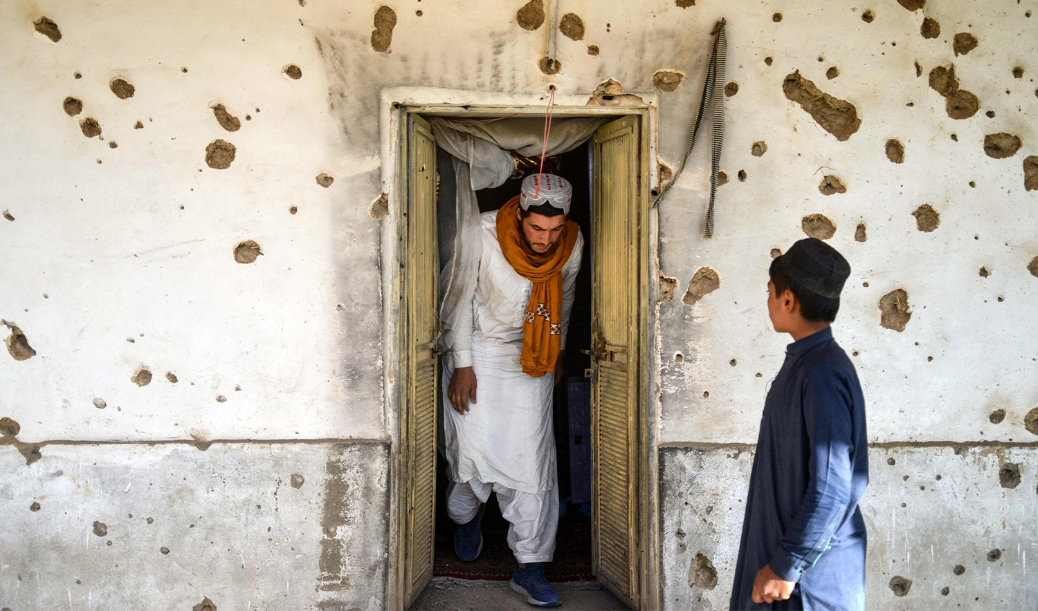 An Afghan man inspects a damaged house, following cross-border fire from Pakistan's artillery shelling, at a village in the Spin Boldak district of Kandahar on November 7, 2025. (AFP/File)