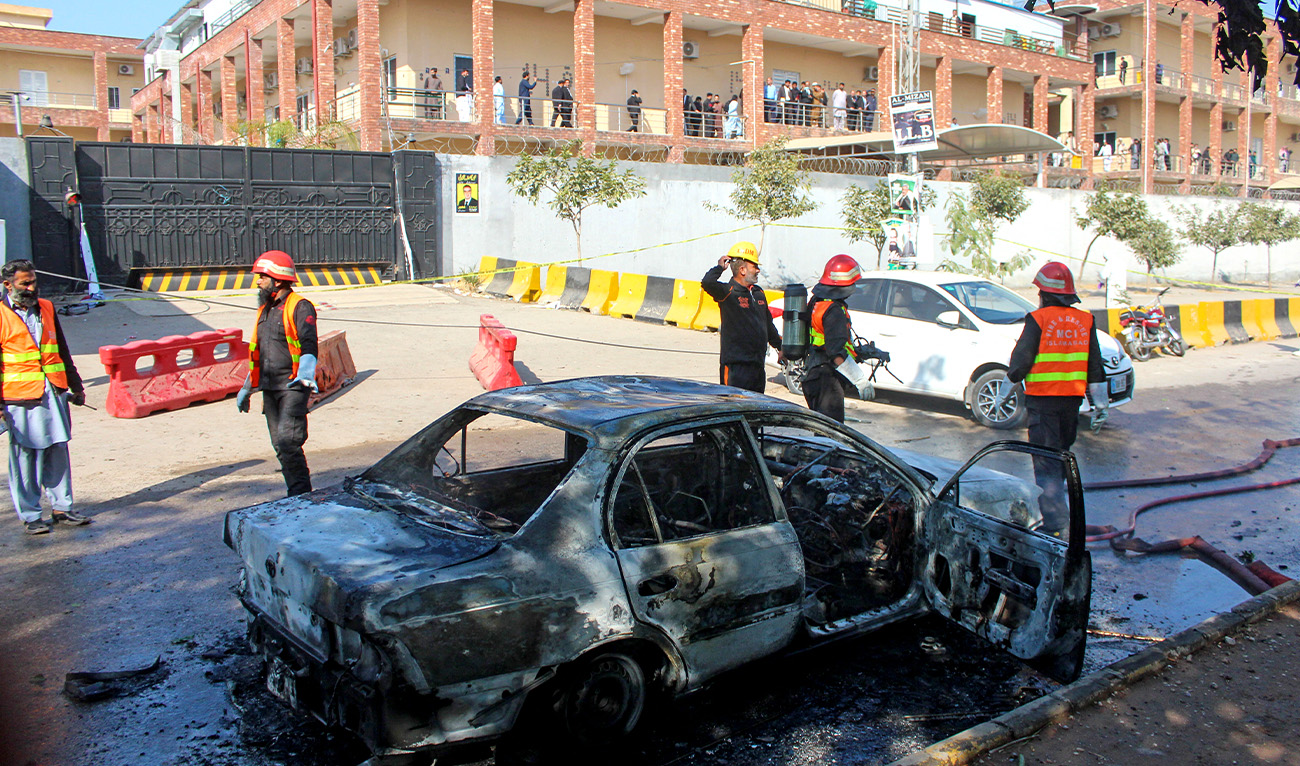 Firefighters douse a car at the suicide blast site in Islamabad on November 11, 2025. (AFP)