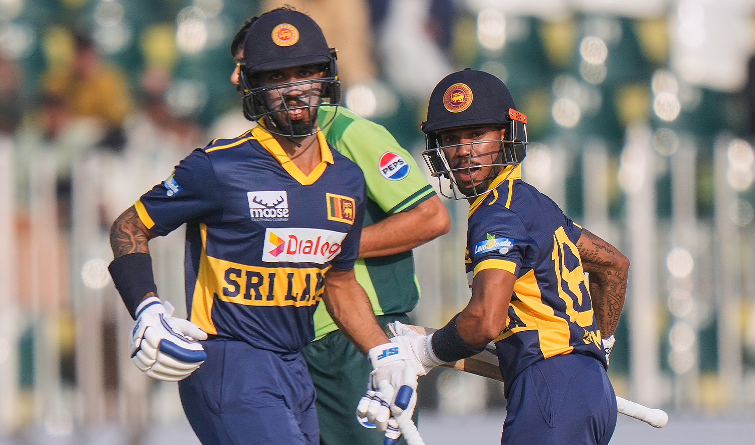 Sri Lanka's Pathum Nissanka, right, Kamil Mishara run between the wickets during the second one day international cricket match between Pakistan and Sri Lanka, in Rawalpindi, Pakistan, on Nov. 14, 2025. (AP)